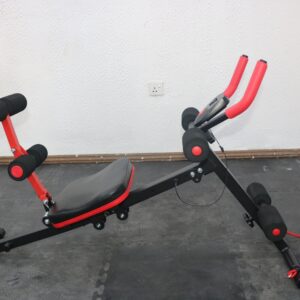 A black and red ab trainer machine with a padded backrest, adjustable seat, and multiple roller pads. The machine is designed for abdominal and back workouts.