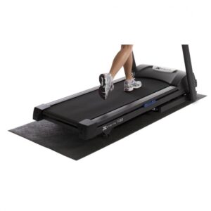 A black treadmill mat placed beneath an Xterra 150 treadmill. A person is running on the treadmill, and their feet are visible above the mat. The mat appears to be thick and textured, designed to protect the floor from noise and damage caused by the treadmill.