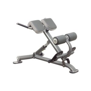 Impulse IT7010 Multi Hyperextension Bench. A gray hyperextension bench with a padded back and adjustable positions. The bench has a sturdy steel frame and is designed for lower back exercises.