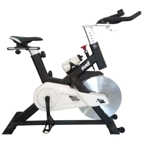 A Fuel SB450 Spin Bike. It's a black and white exercise bike with an adjustable seat and handlebars. The bike has a large flywheel, a digital display, and appears to have magnetic resistance.