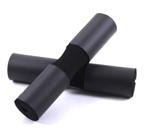 Two black foam barbell pads on a white background. The pads are cylindrical in shape and have a raised center section. They are designed to be placed on a barbell to provide padding and comfort during exercises like squats or bench presses.