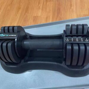 A black adjustable dumbbell with the brand "BFIT FITNESS" printed on it. The dumbbell has a digital display that shows the weight setting, which ranges from 2.5 to 12.5 kilograms. The dumbbell also has a handle and a base for storing the weights.