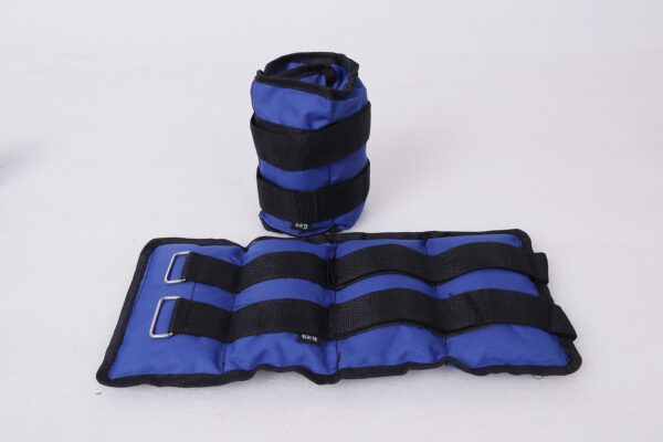 A pair of blue ankle weights with black straps. The weights are filled with sand and have adjustable straps for a secure fit.