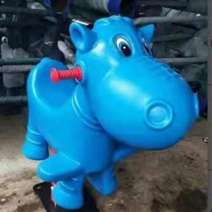 A blue plastic hippopotamus rocking toy for children. The hippo has a friendly face and a spring-loaded base that allows it to rock back and forth. A red bolt is visible on the back of the hippo.