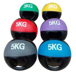 Six medicine balls of different colors and weights arranged in a grid. The top row has two balls labeled "3KG," the middle row has two balls labeled "5KG," and the bottom row has two balls labeled "5KG." The balls are black with a colored top half and a black handle.